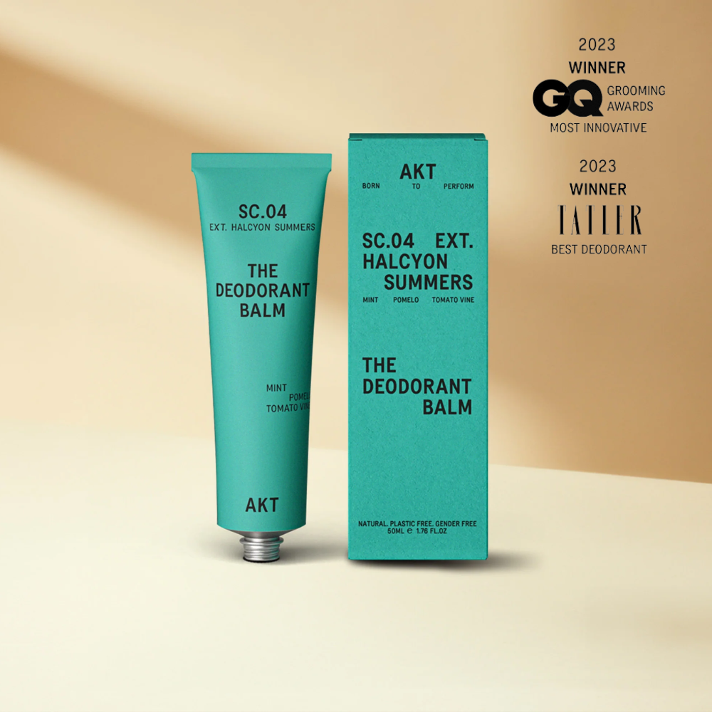 Deodorant balm in Aqua green metal tube standing upright next to Aqua packaging box