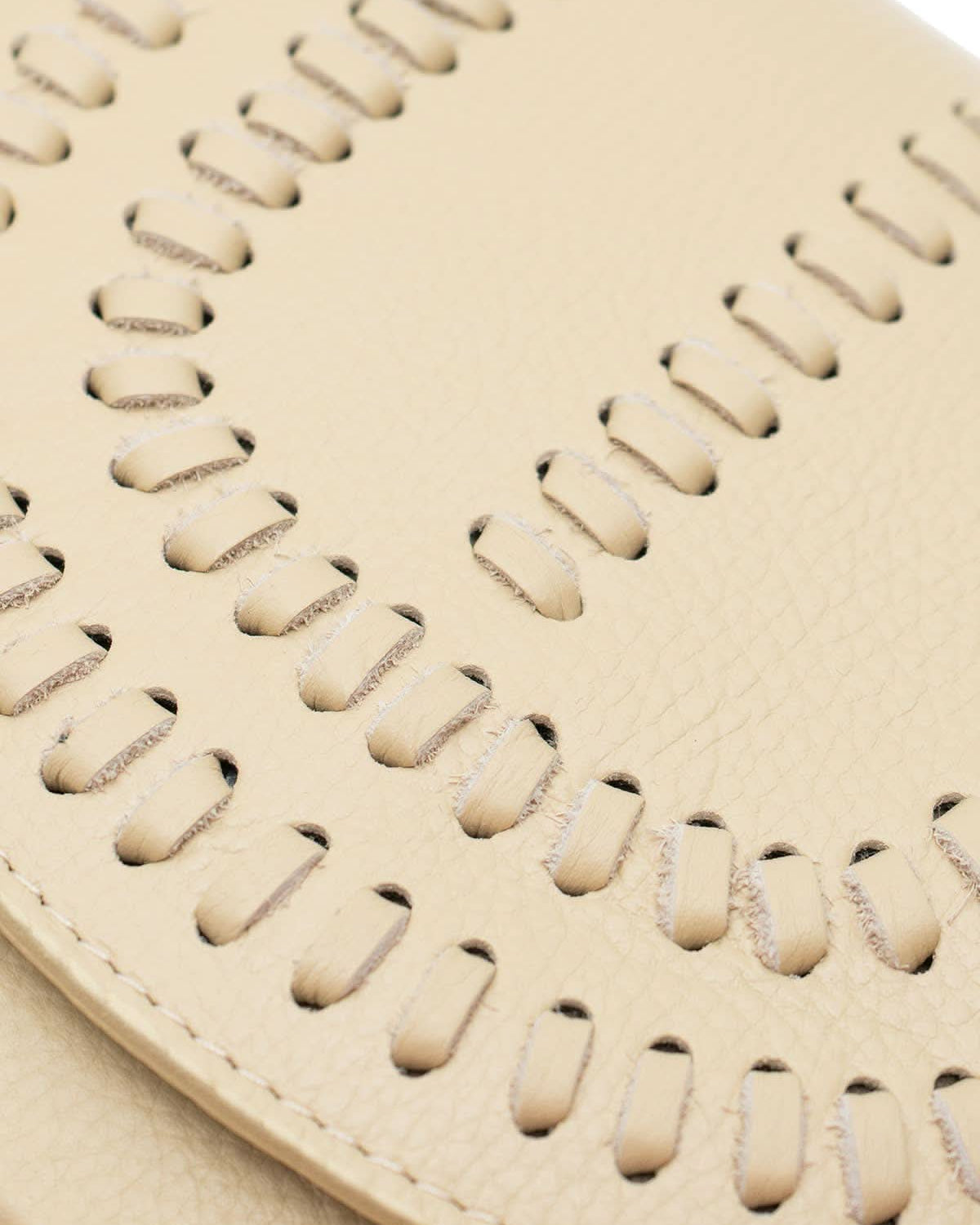 Cream colored leather crossbody bag with magnetic front clap and leather woven geometric design and gold Metal details