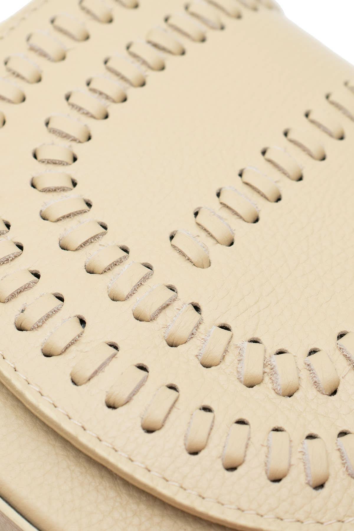 Cream colored leather crossbody bag with magnetic front clap and leather woven geometric design and gold Metal details