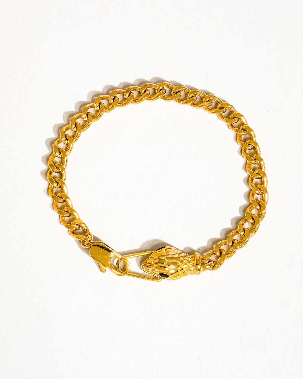 Gold chain bracelet on a white background