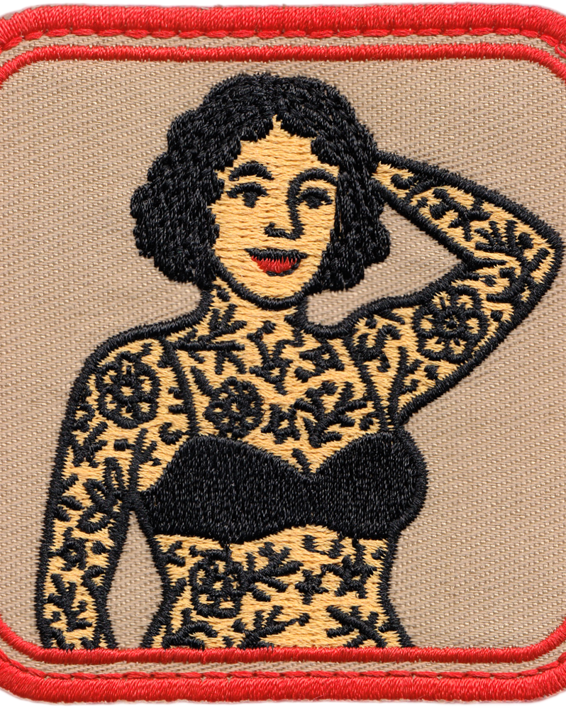 Embroidered patch of a woman with tattoos on a beige background with red border