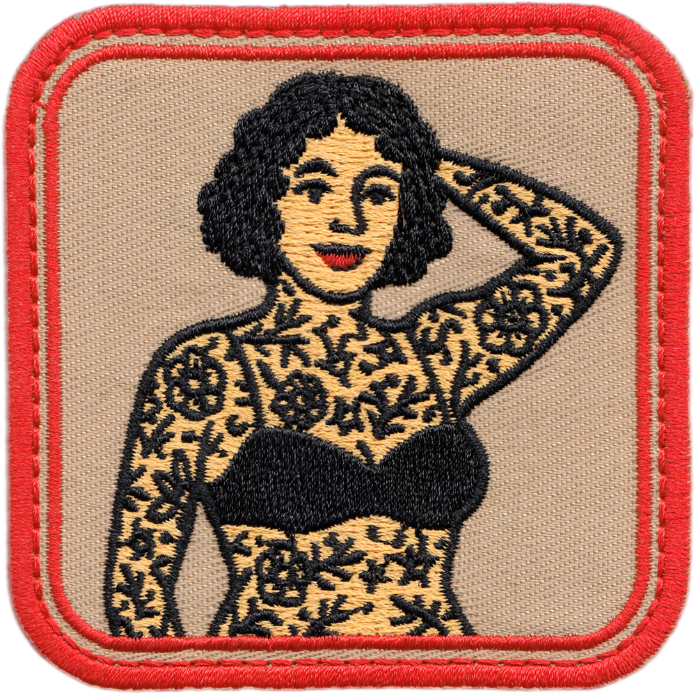 Embroidered patch of a woman with tattoos on a beige background with red border