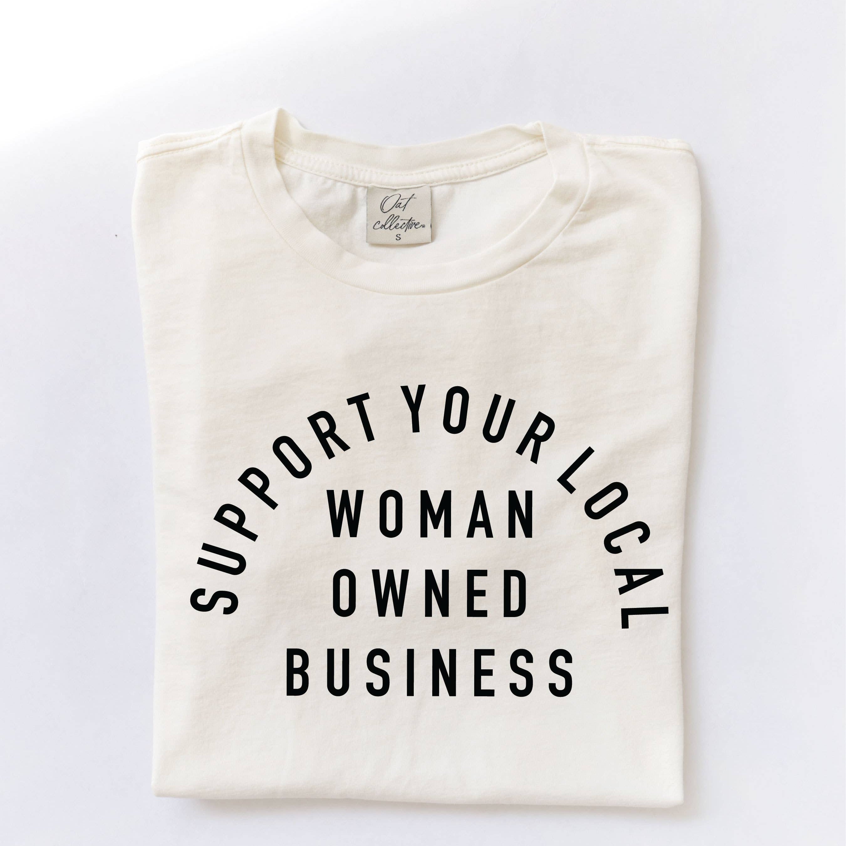 Folded shirt with 'Support Your Local Woman Owned Business' text on a white background