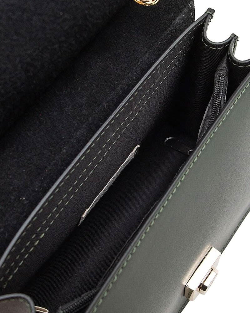 Inside view of Black leather handbag with gold details and clasp sitting against white background