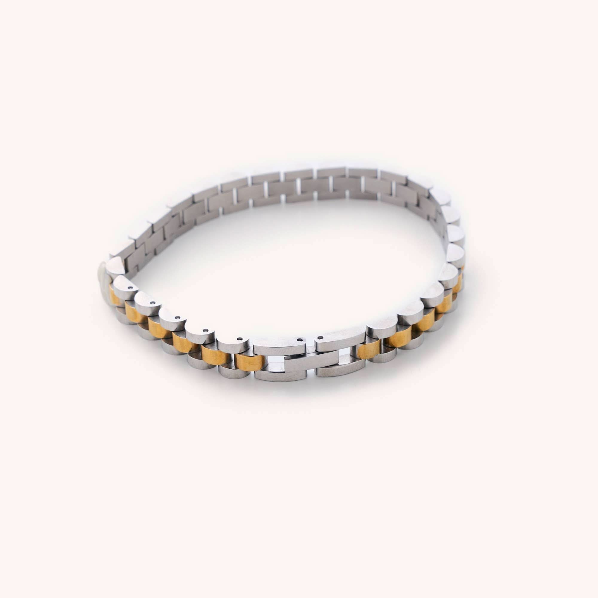 Waterproof silver and gold Cuban Link 6" plus a 2" extender laying on white background