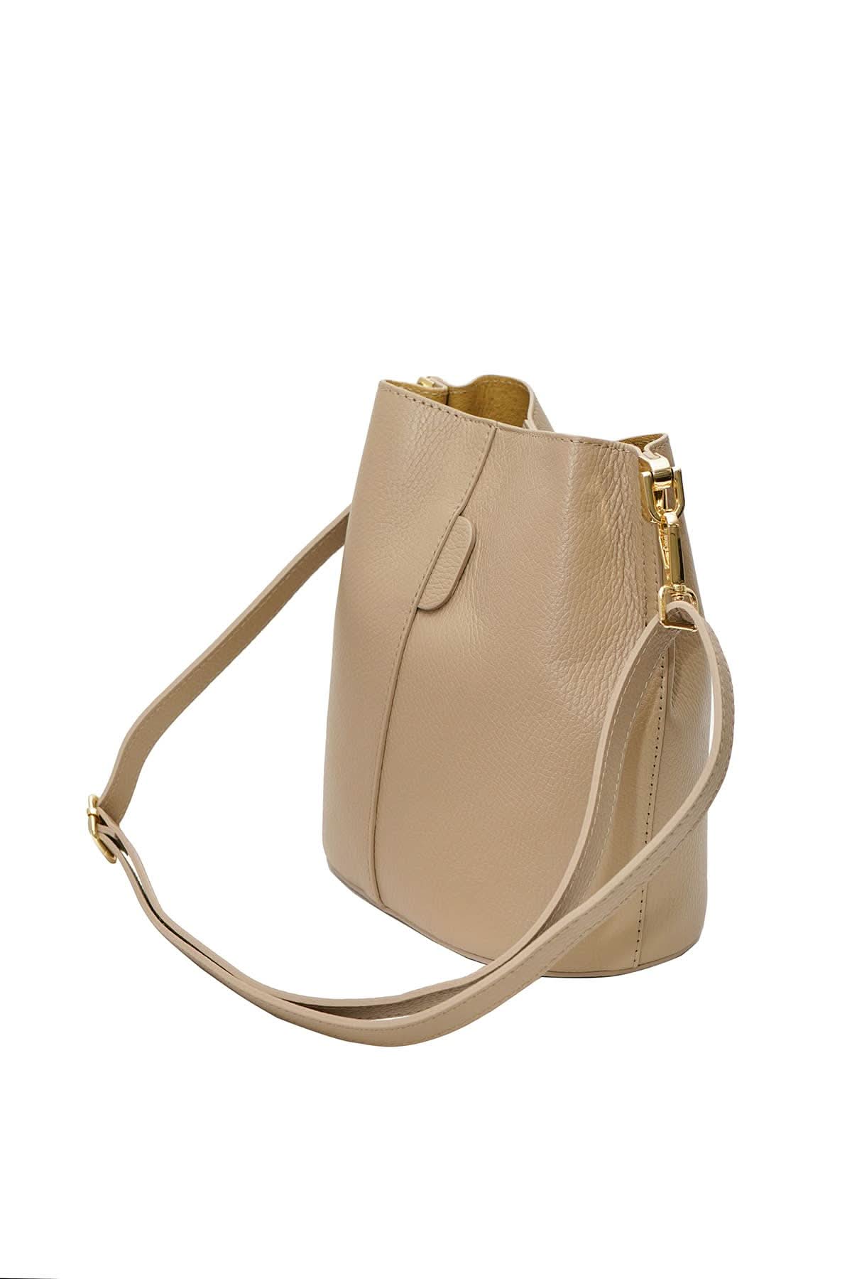 Beige handbag with a gold zipper on a white background