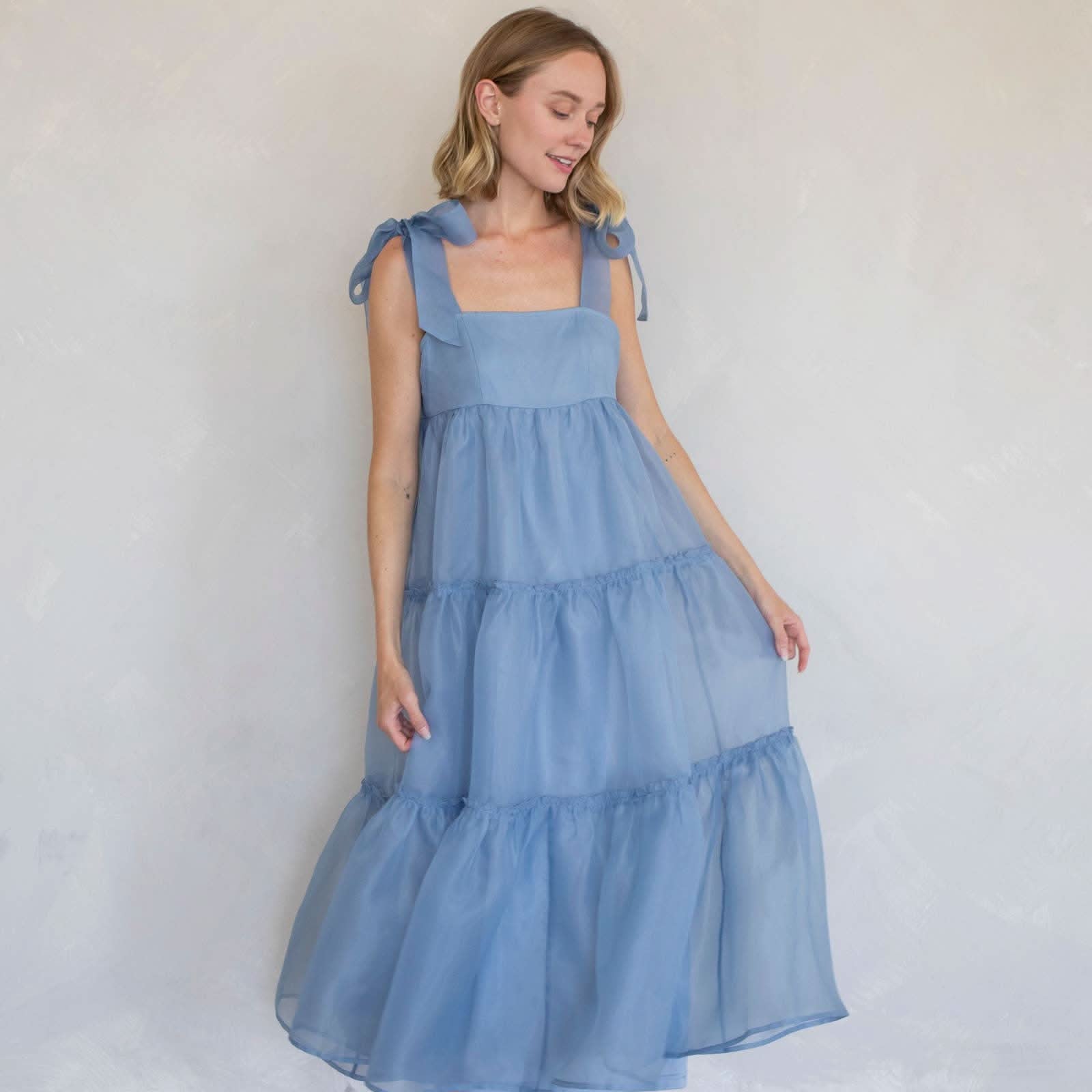 Woman wearing a blue tiered dress light blue color