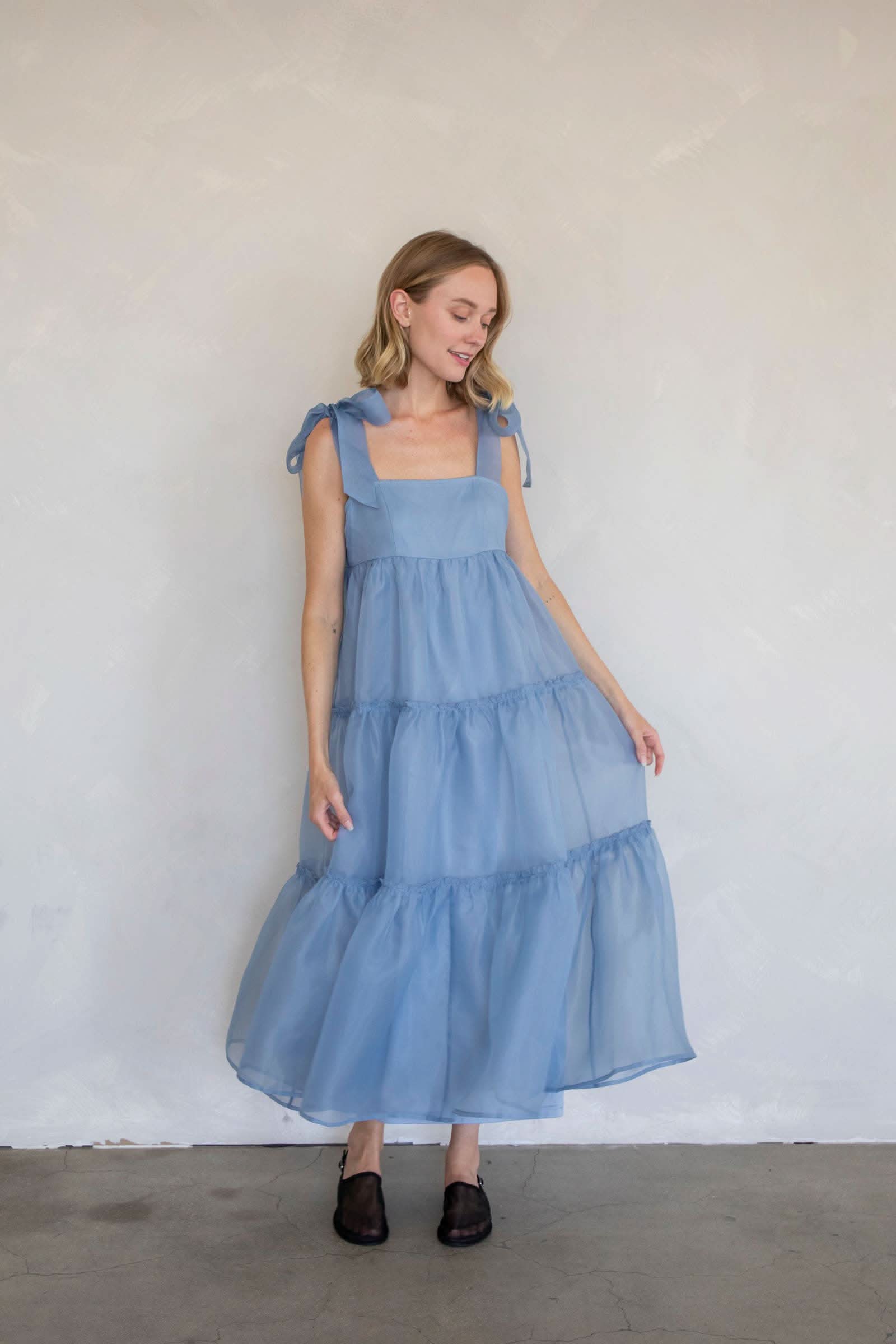 Woman wearing a blue tiered dress light blue color