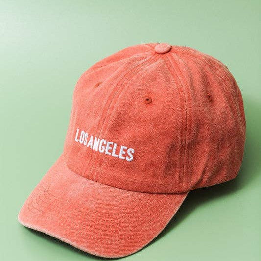 Red cap with 'Los Angeles' text on a green background