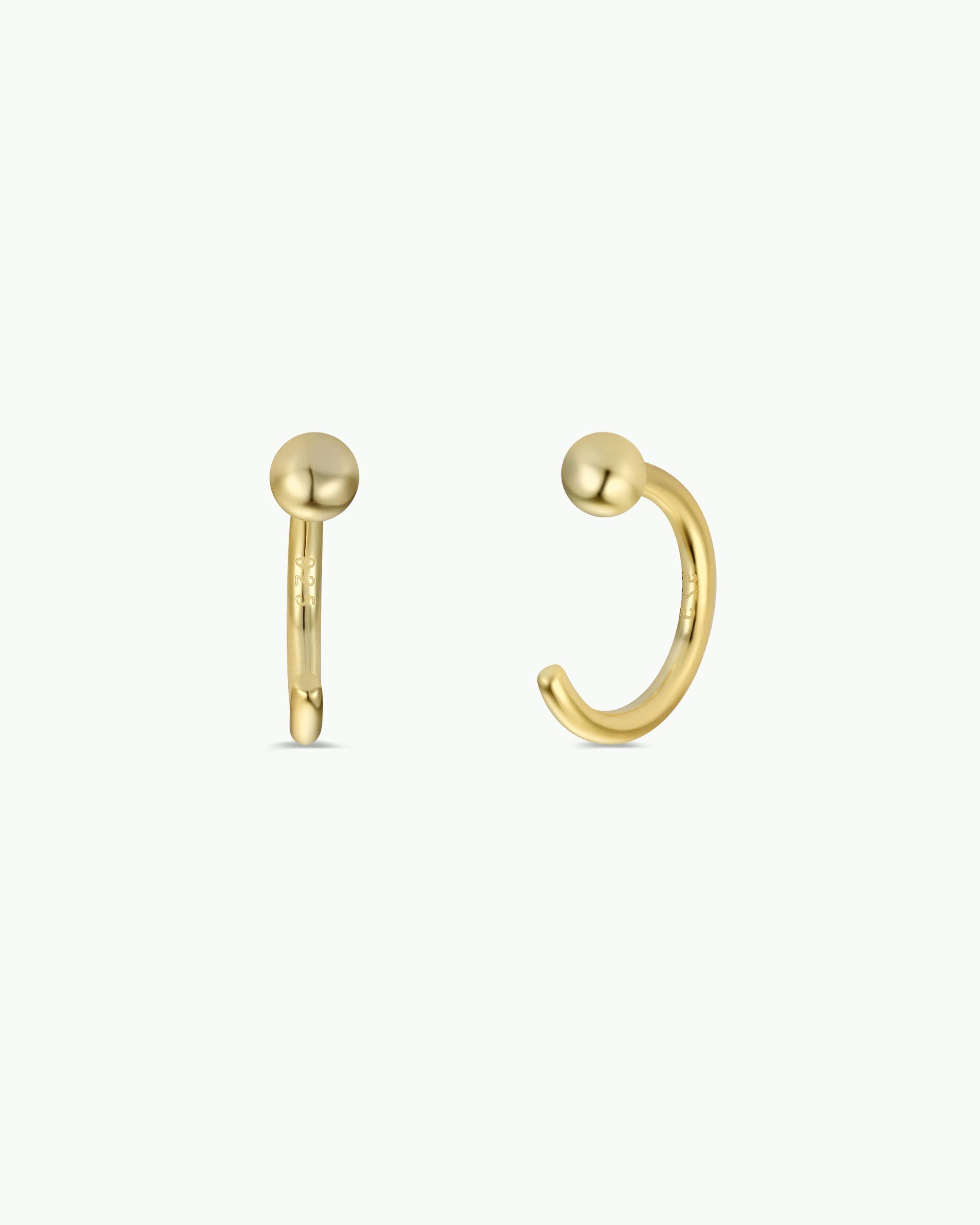 Gold hoop earrings on a white background