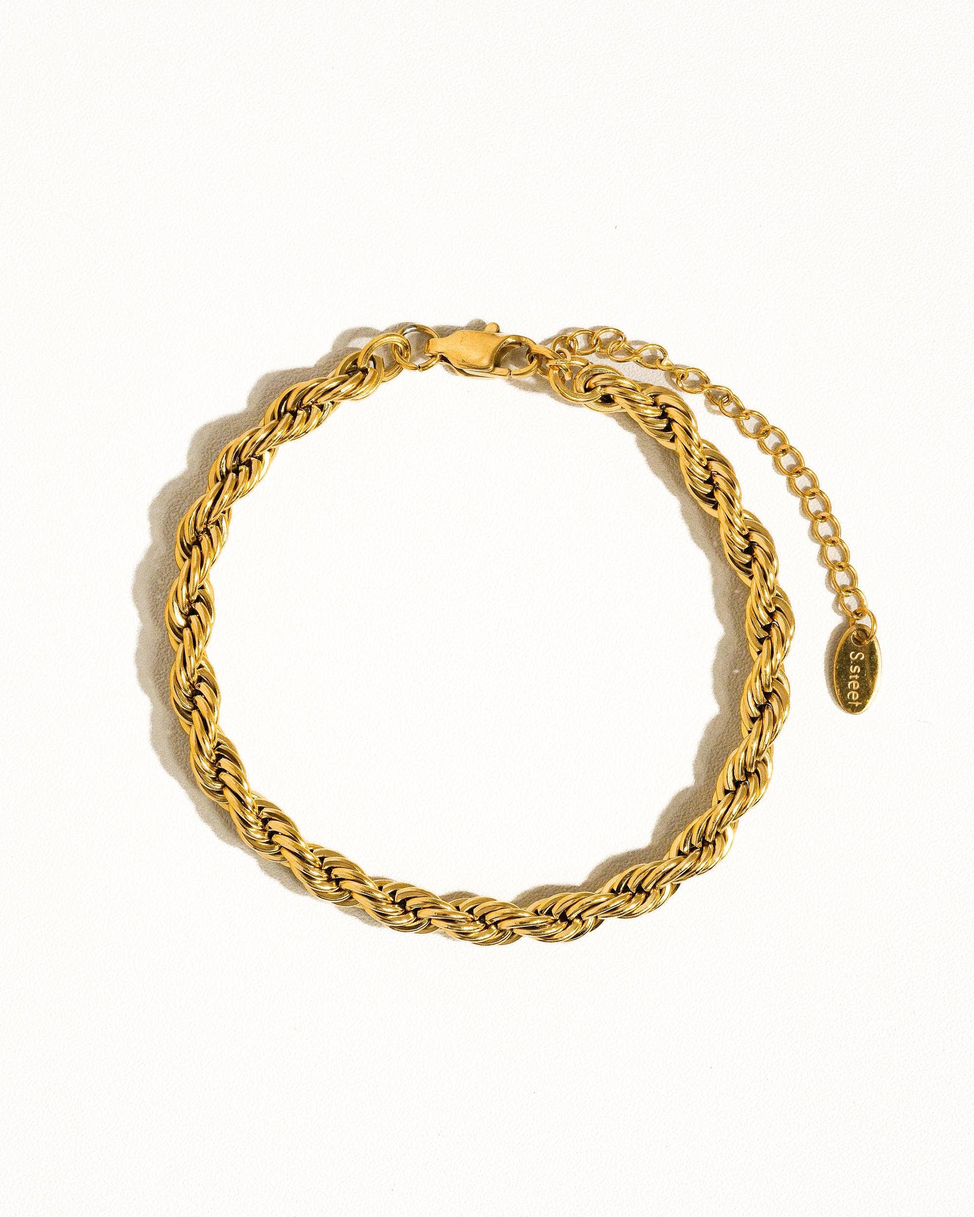 Gold chain bracelet on a white background