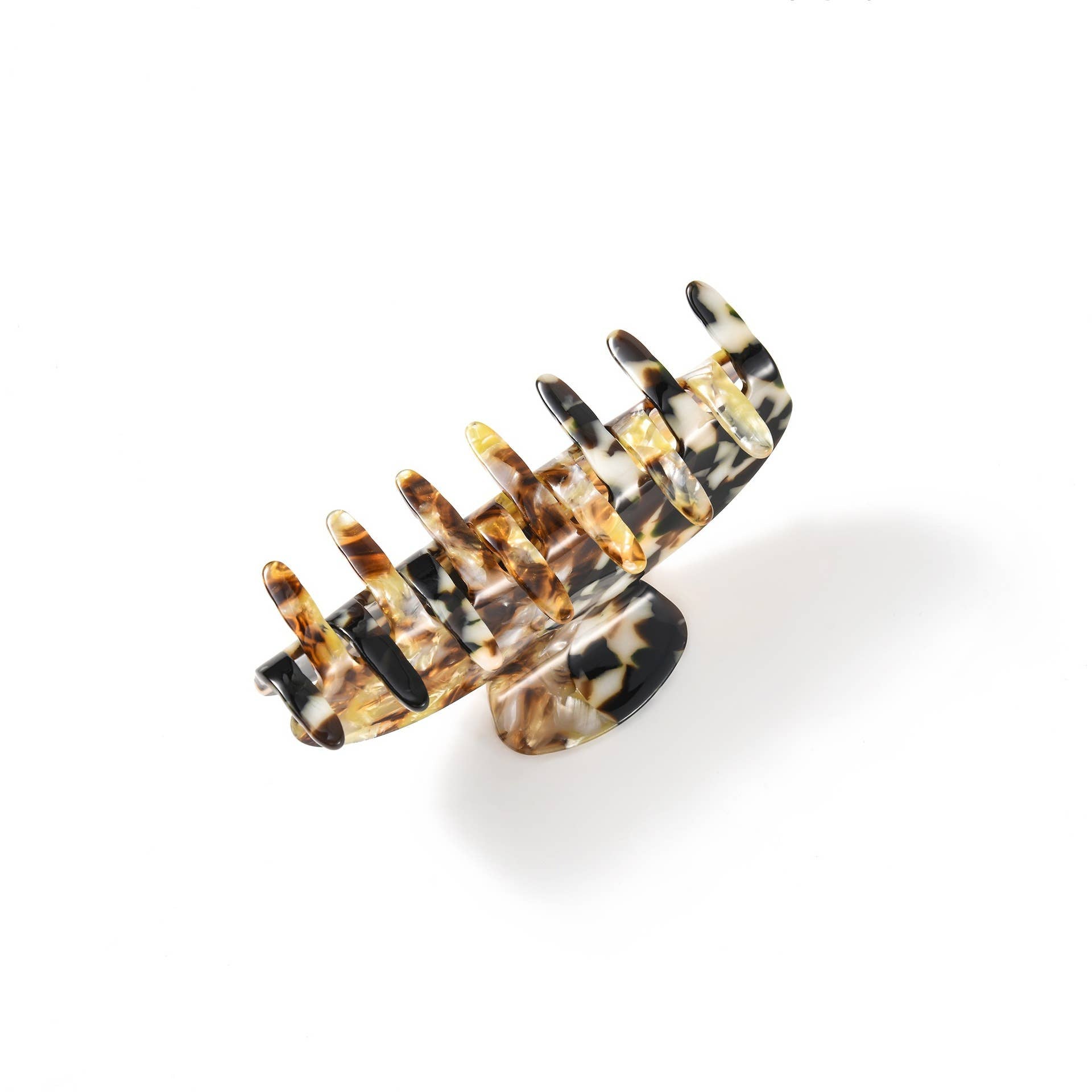 Tortoiseshell patterned hair comb on a white background