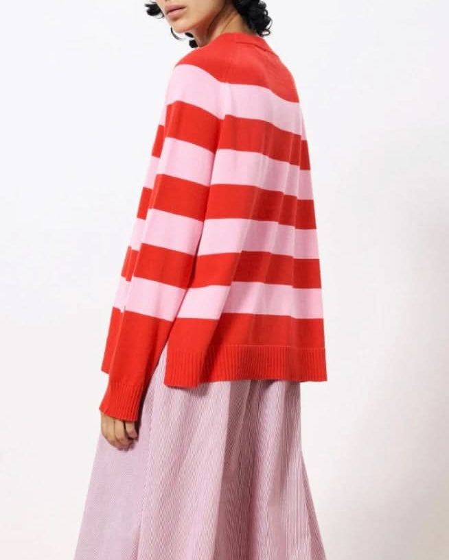 Woman wearing pink and red horizontal thick striped sweater