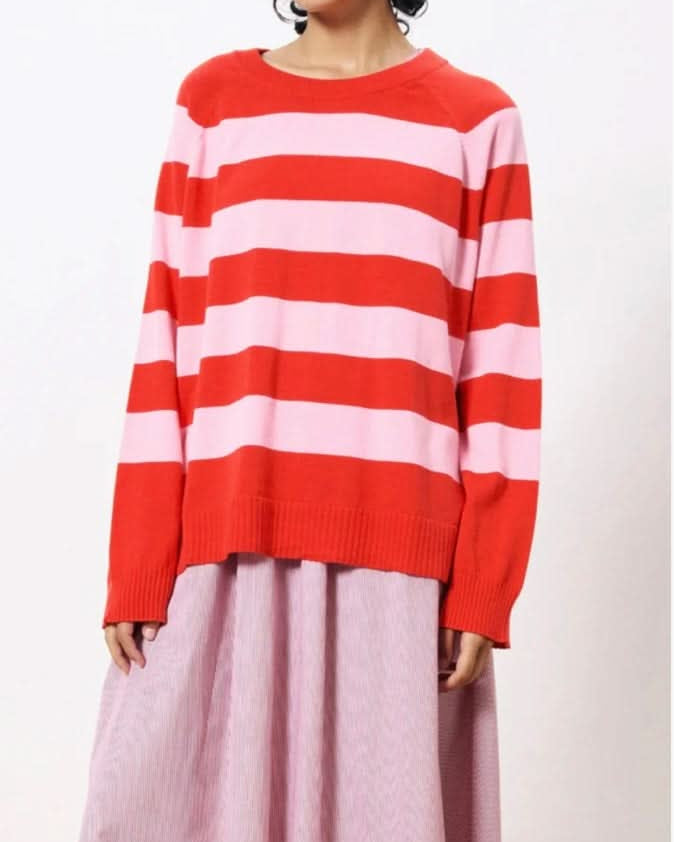 Woman wearing pink and red horizontal thick striped sweater