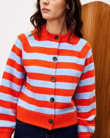 Person wearing a red and white striped sweater with buttons.