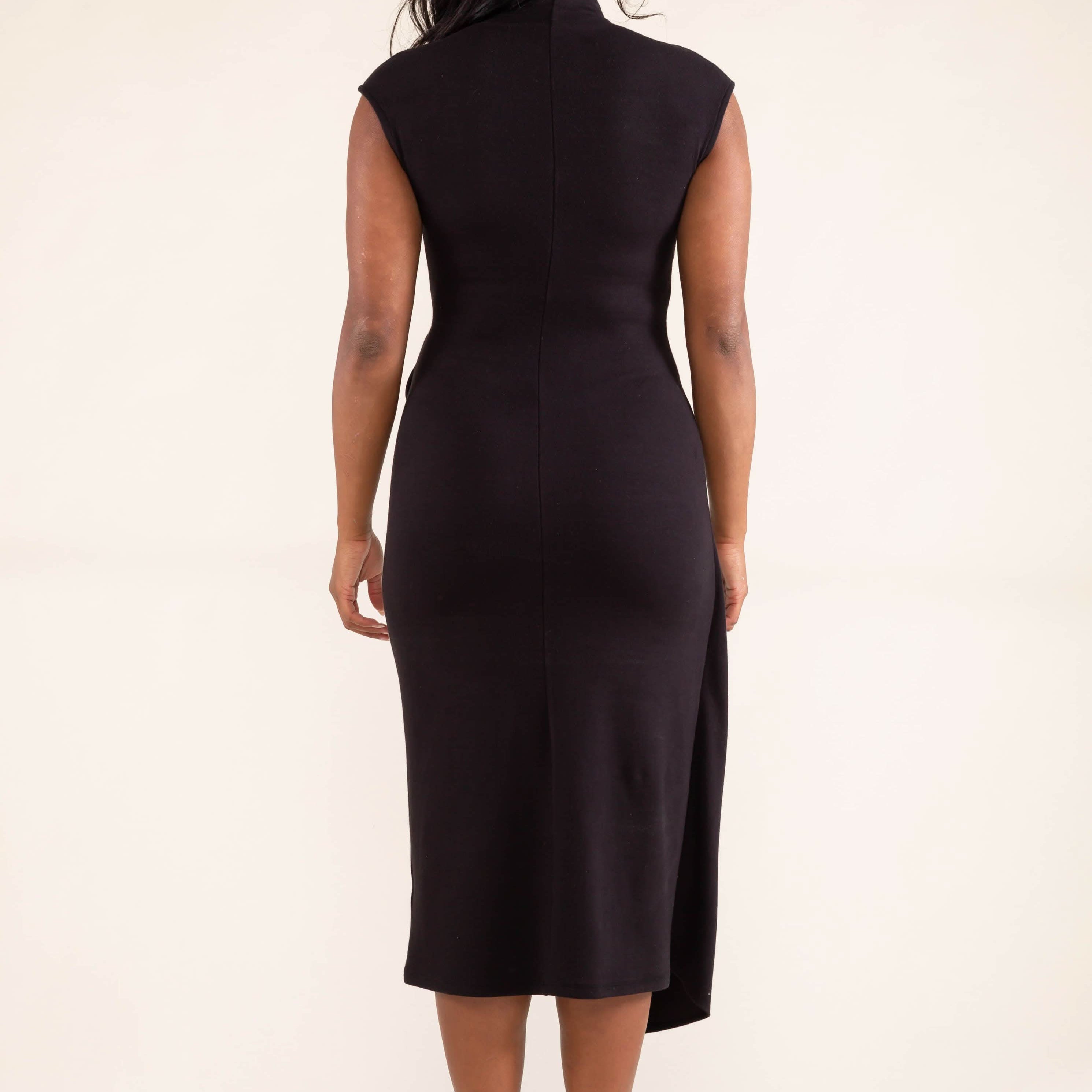 Woman wearing a black sleeveless dress on a beige background