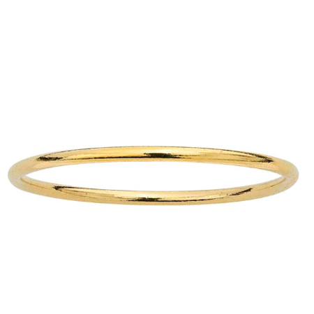 Simple thin gold ring for stacking laying on a white background