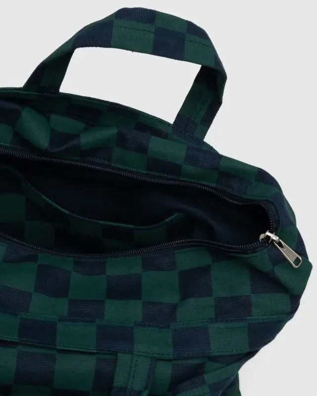Inside details of BAGGU square navy and green checkered tote bag with handles and adjustable straps on white background