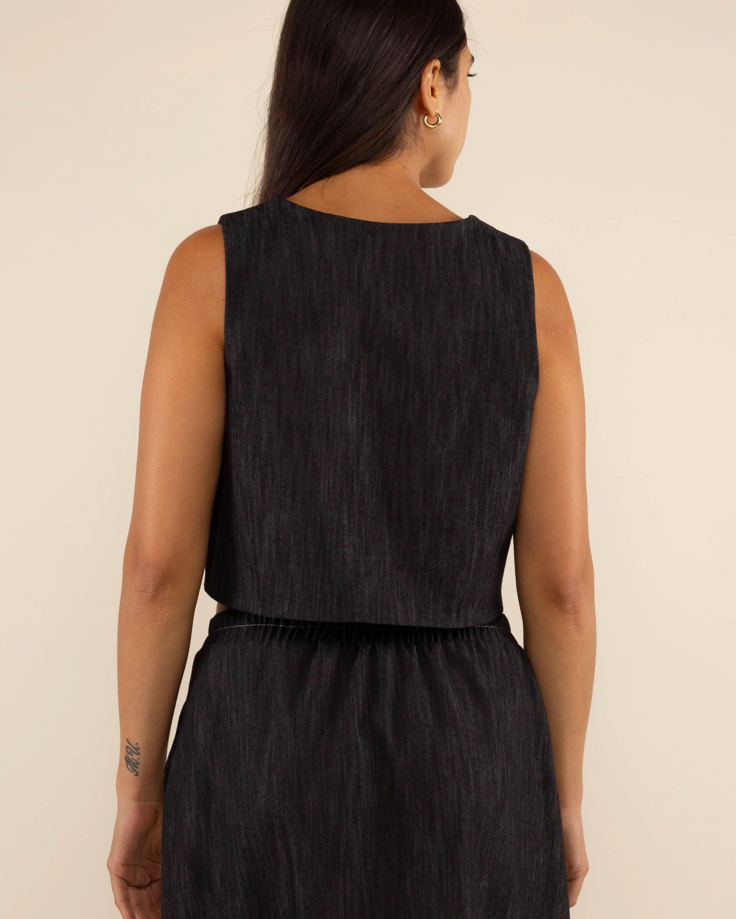 Woman wearing a black sleeveless top and skirt Laney Black Denim Vest