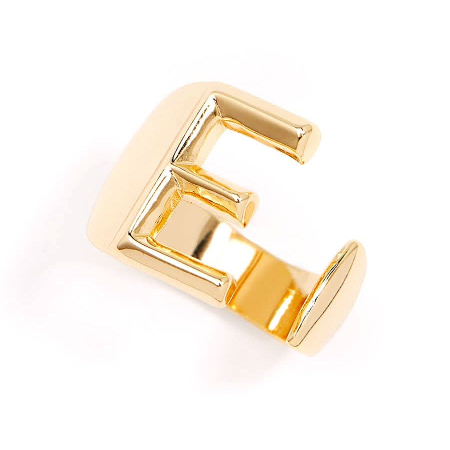 Gold adjustable letter ring on white background in letter E