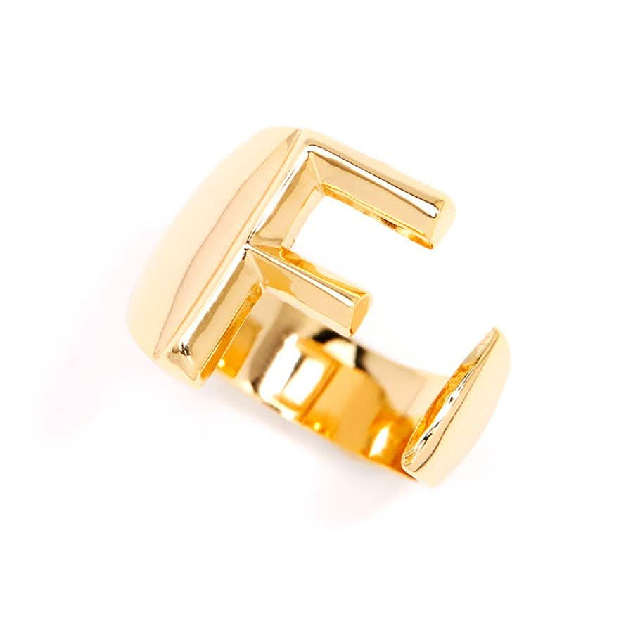 Gold adjustable letter ring on white background in letter F