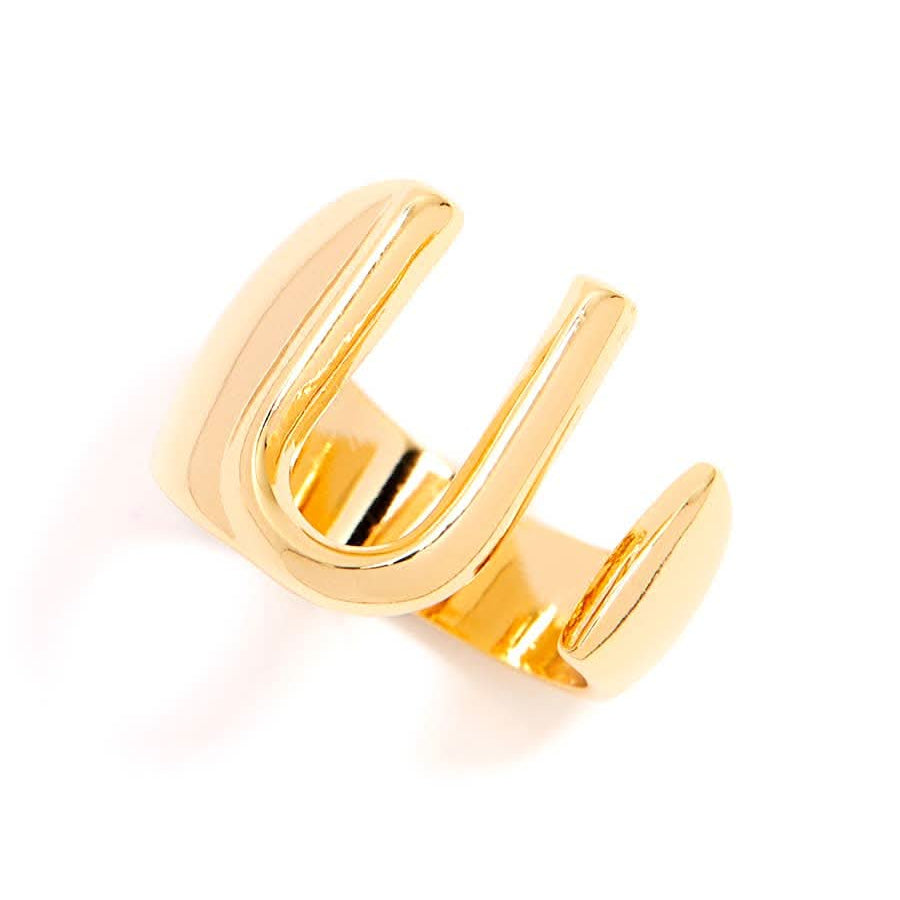 Gold adjustable letter ring on white background in letter U
