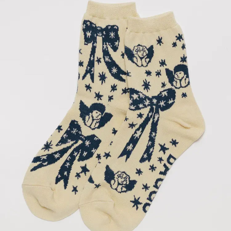 Beige socks with blue angel and bow designs on a white background