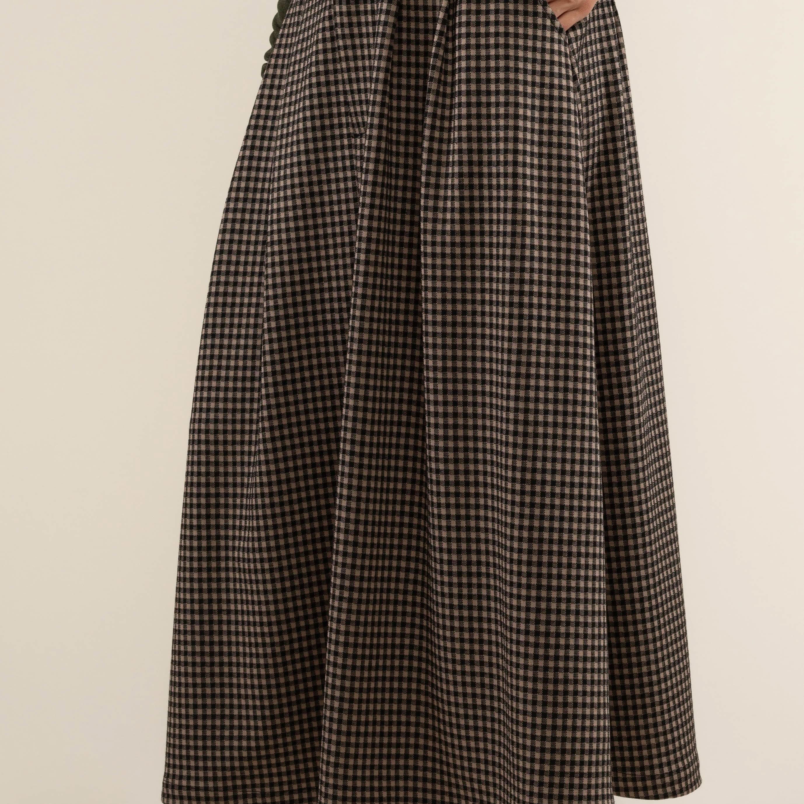 Person wearing a plaid skirt Maxi skirt with zipper and button closure at front.