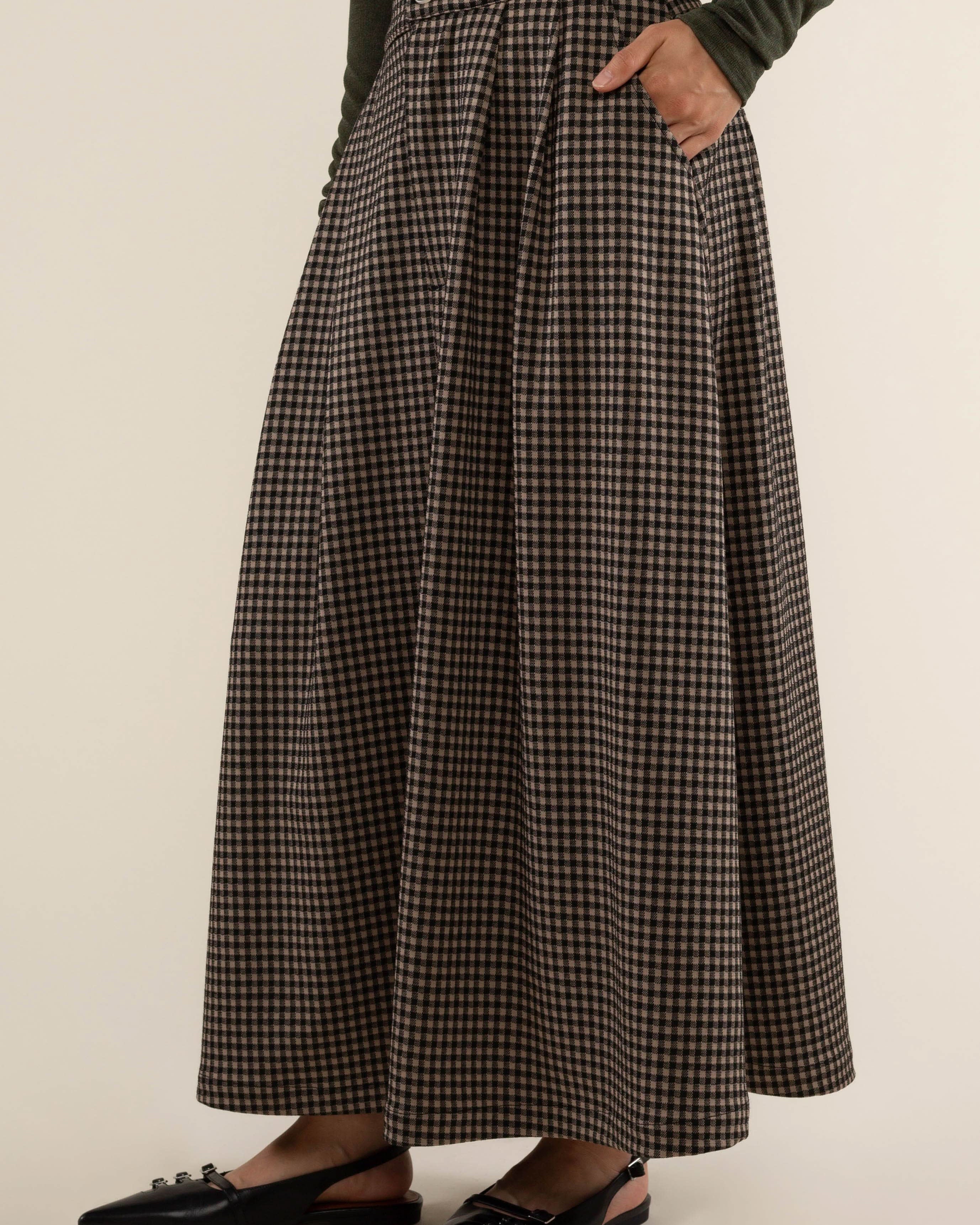 Person wearing a plaid skirt Maxi skirt with zipper and button closure at front.