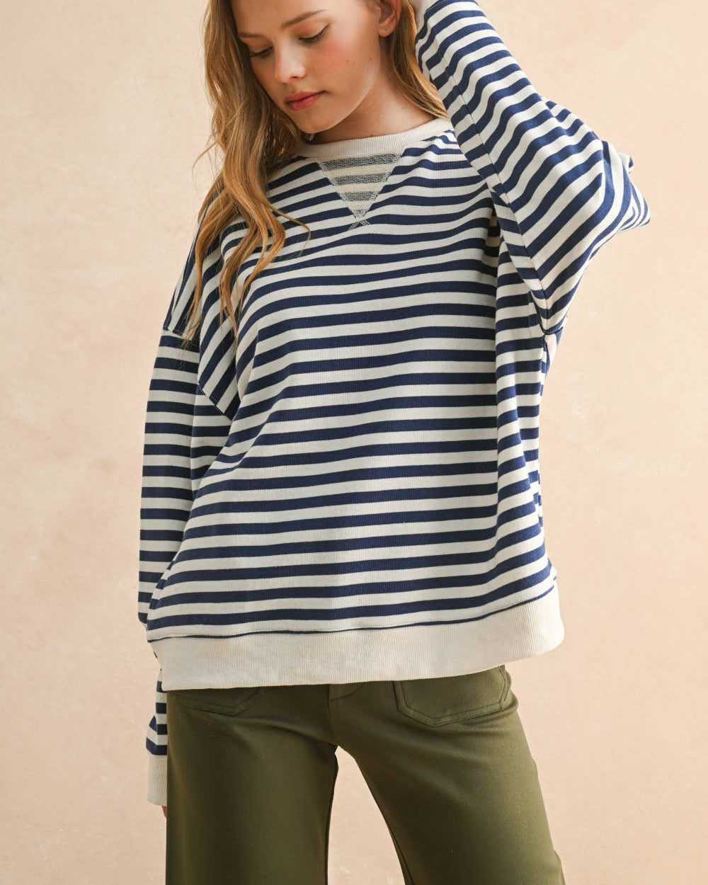 Cozy up in this striped knitted pullover that's equal parts comfort and style.