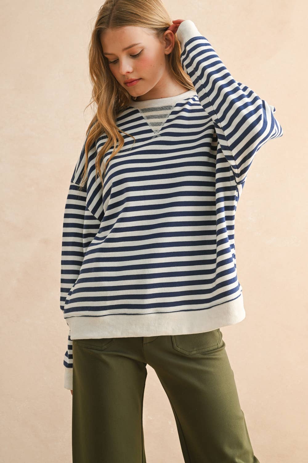 Cozy up in this striped knitted pullover that's equal parts comfort and style.