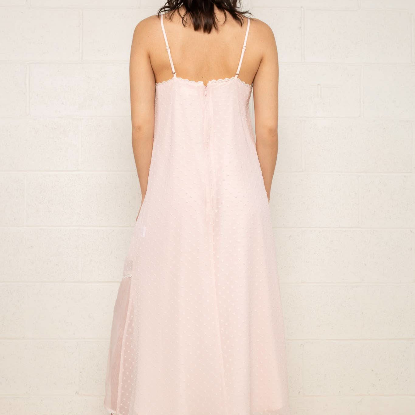 The Flirty Dress Woman wearing a light pink slip dress