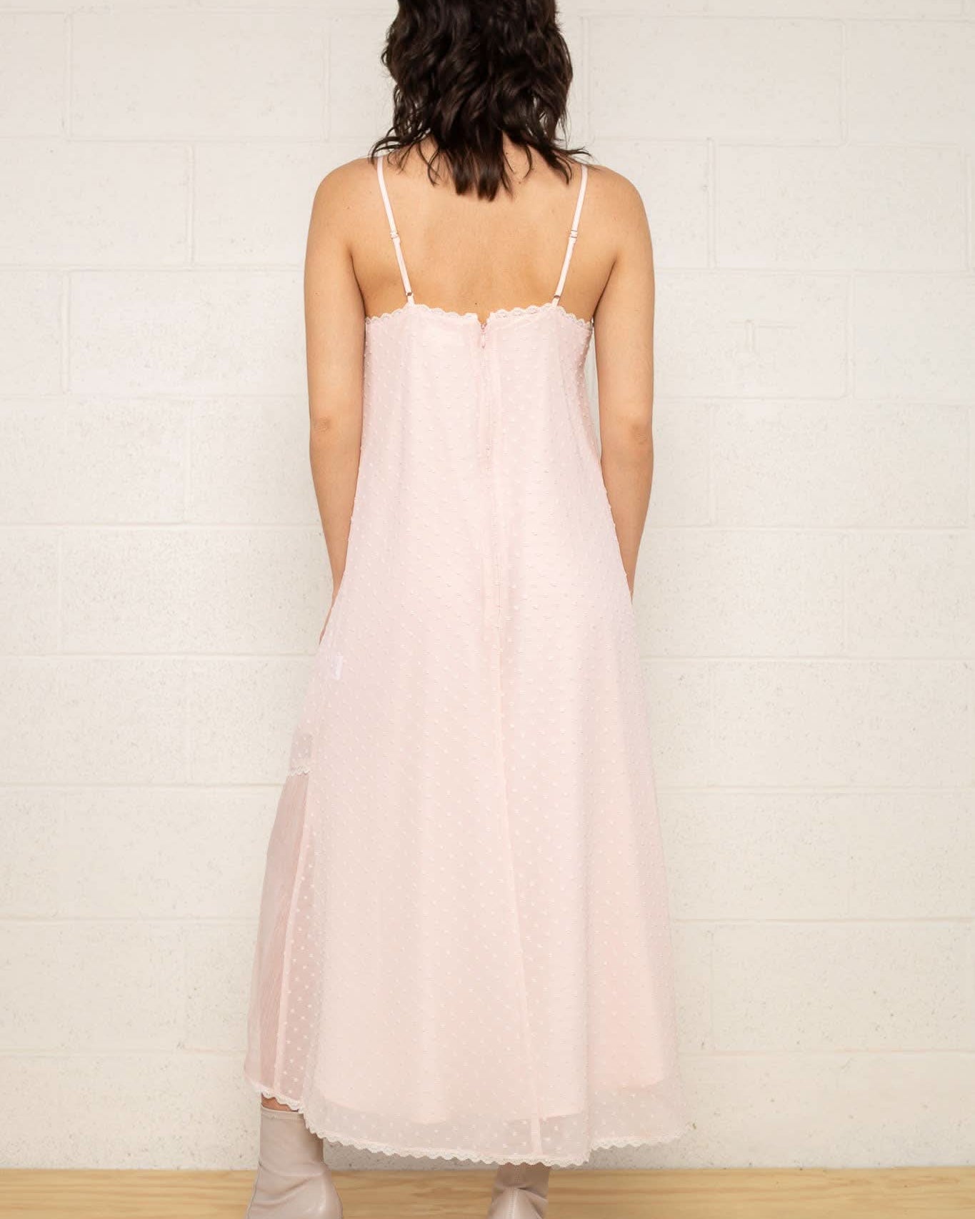 The Flirty Dress Woman wearing a light pink slip dress