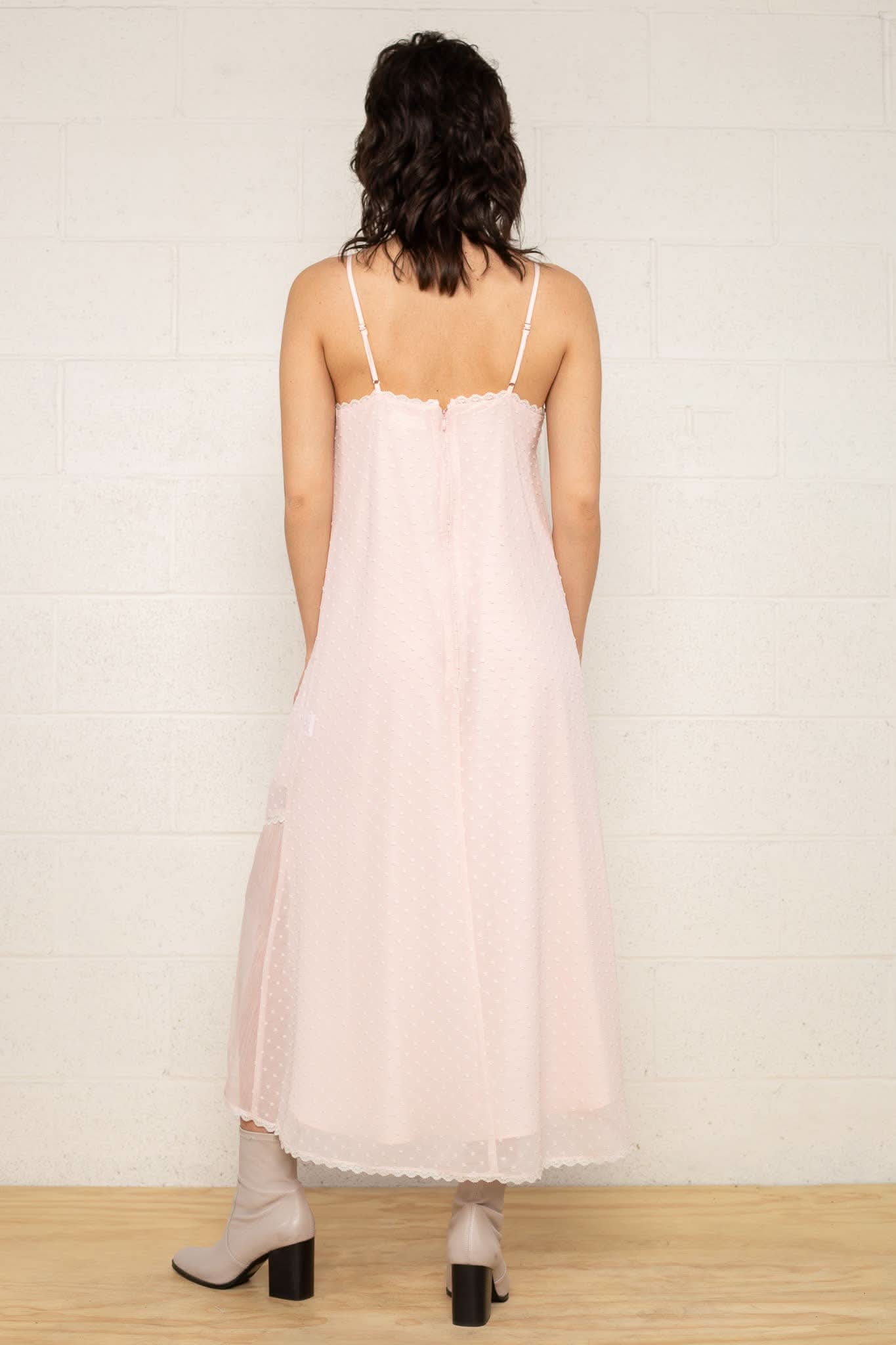 The Flirty Dress Woman wearing a light pink slip dress