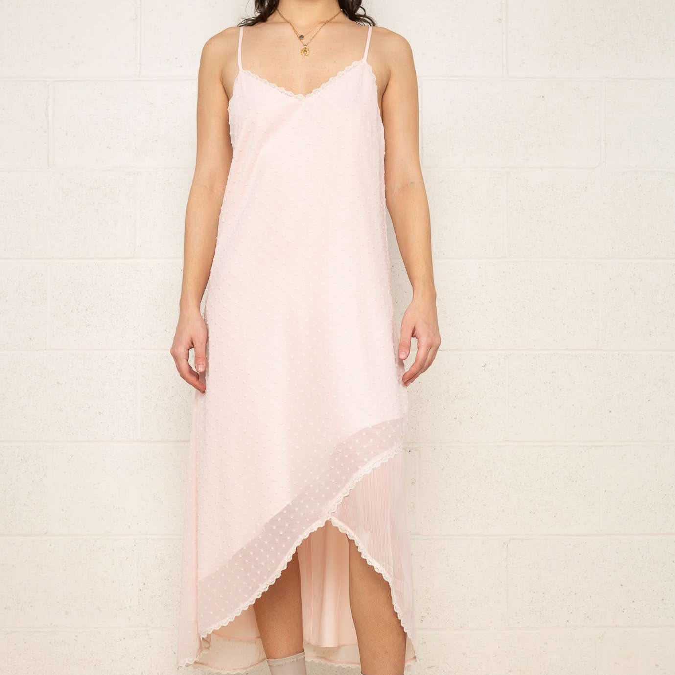The Flirty Dress Woman wearing a light pink slip dress
