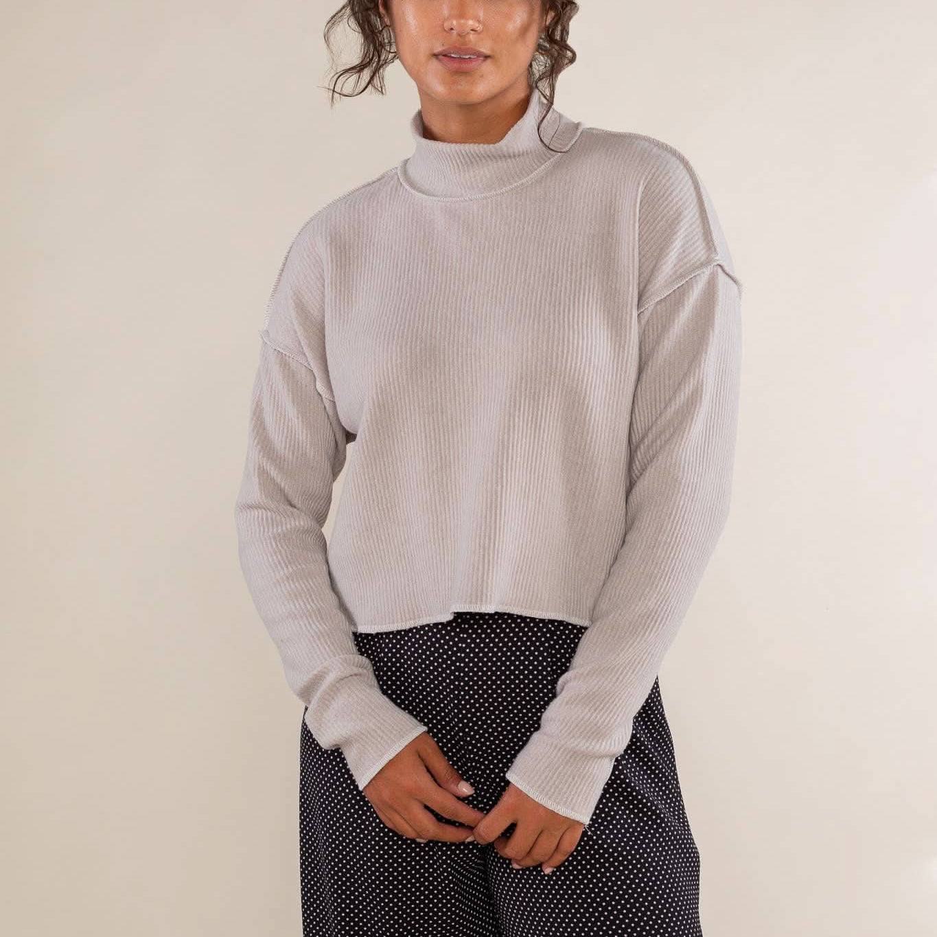Woman wearing a light gray sweater