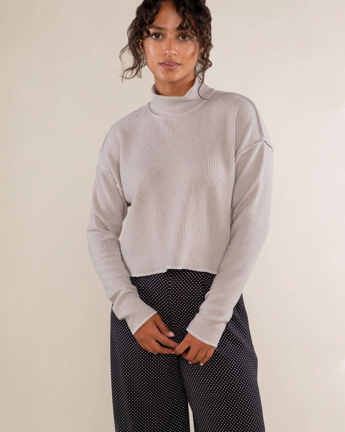 Woman wearing a light gray sweater