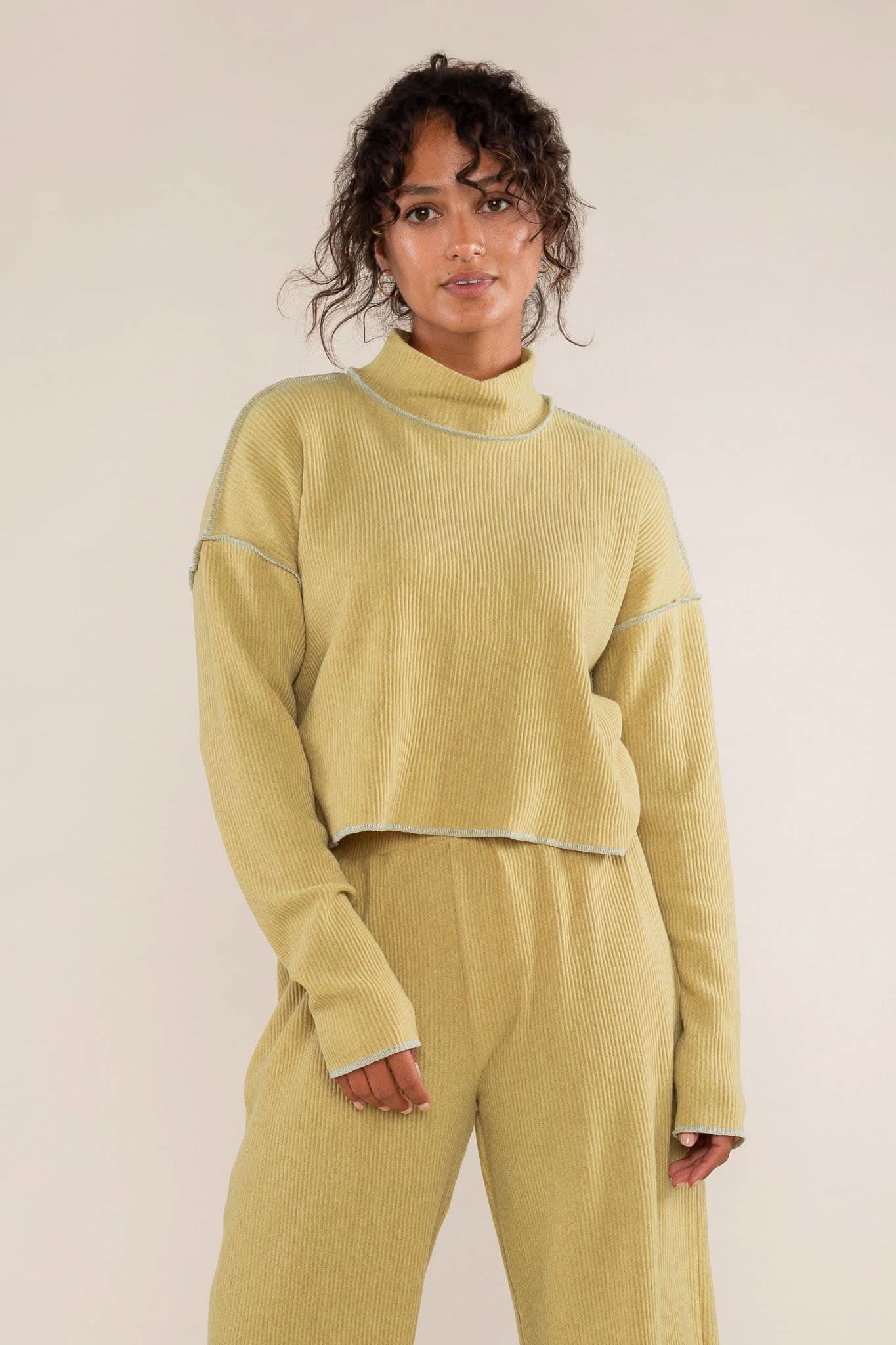 Woman wearing a mustard yellow ribbed knit outfit