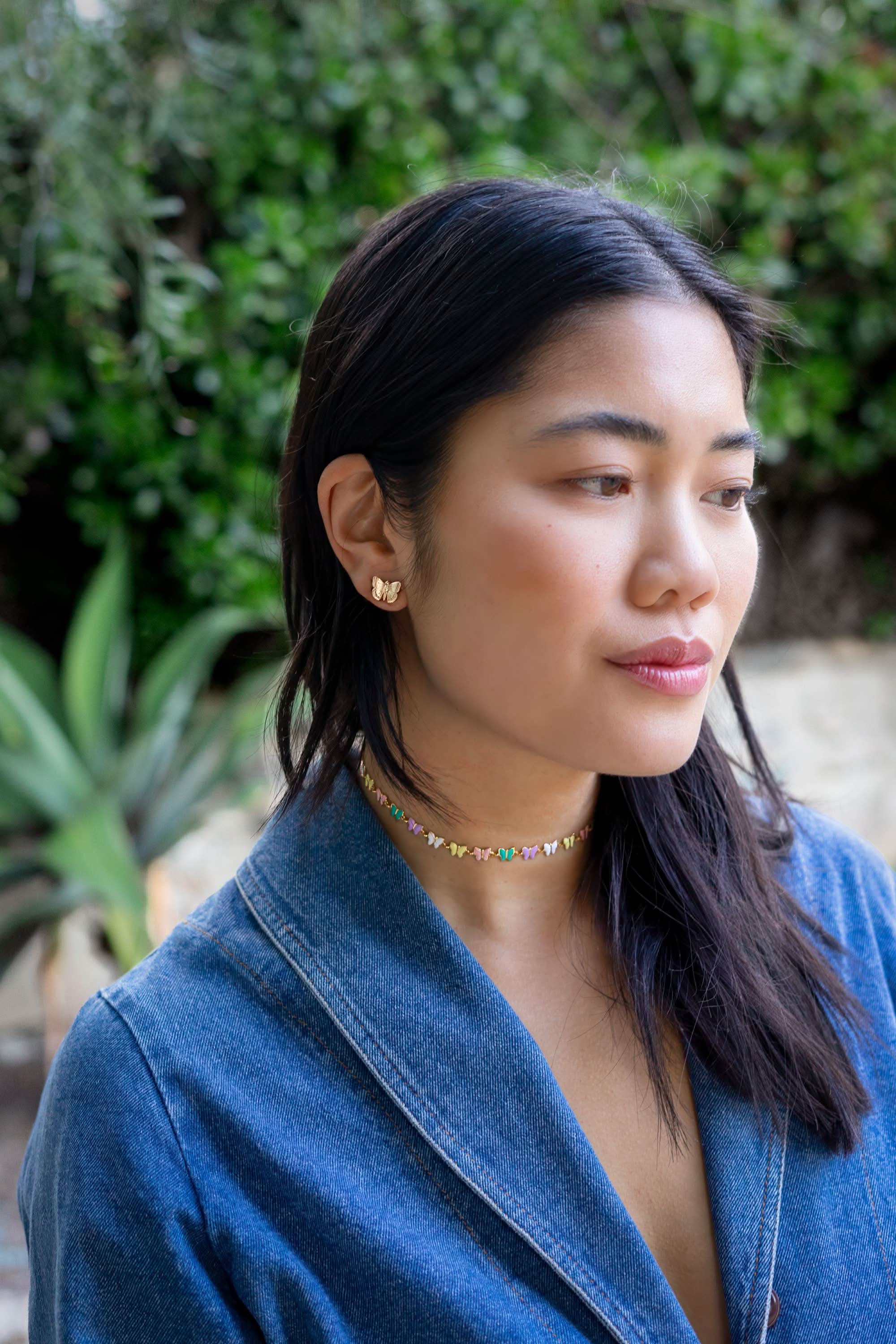 Woman wearing medium sized gold butterfly earring