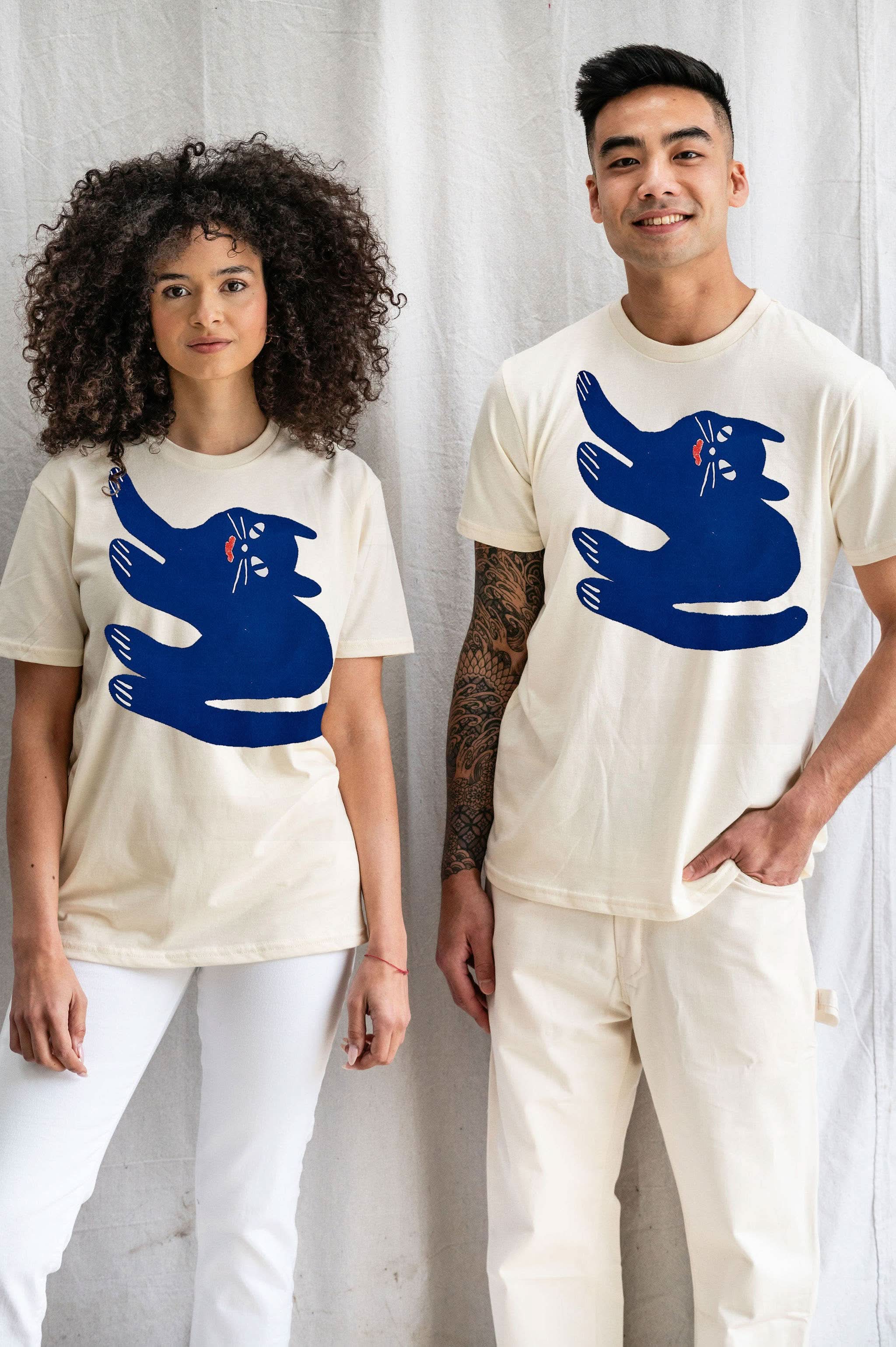Woman and man model both wearing Cream white Tshirt tee with blue sideways smiling cat doodle 