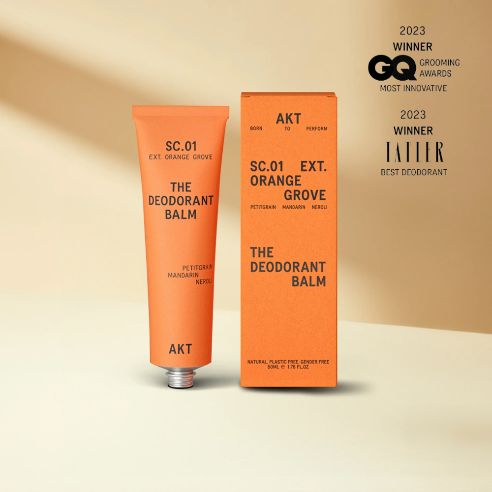 Orange grove deodorant balm in orange tube standing next to orange box packaging 
