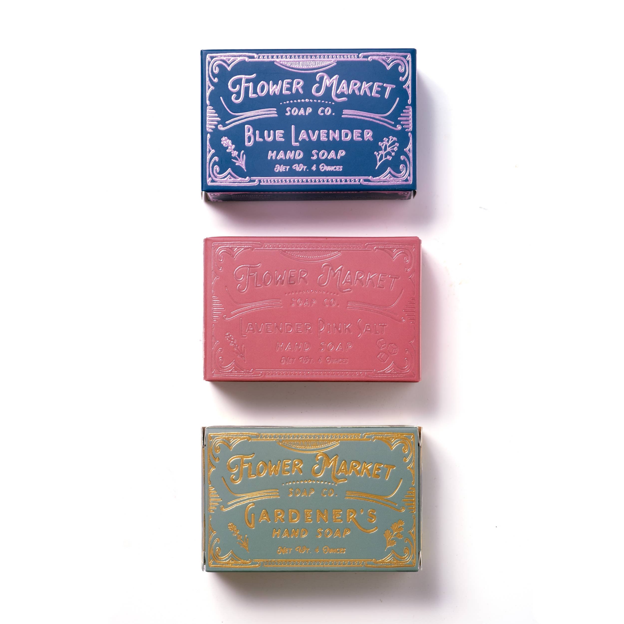 Three bars of soap with decorative packaging on a white background