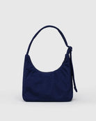View of reverse side of Navy blue handbag with decorative western elements on a light gray background