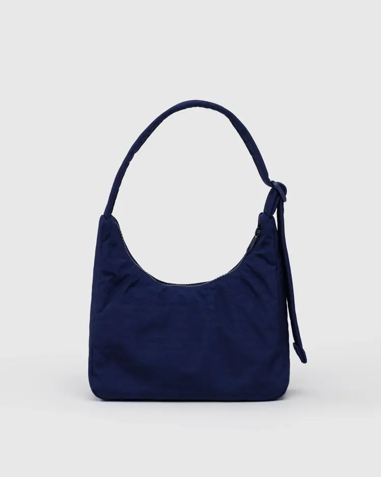 View of reverse side of Navy blue handbag with decorative western elements on a light gray background