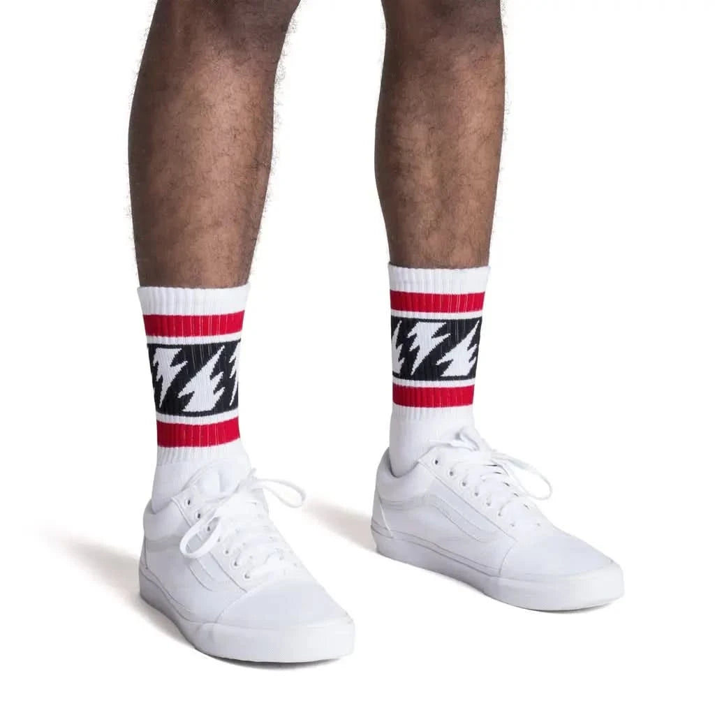 Man wearing White tube socks with red stripe on top, black stripe with white lighting bolts in middle and red stripe on bottom 