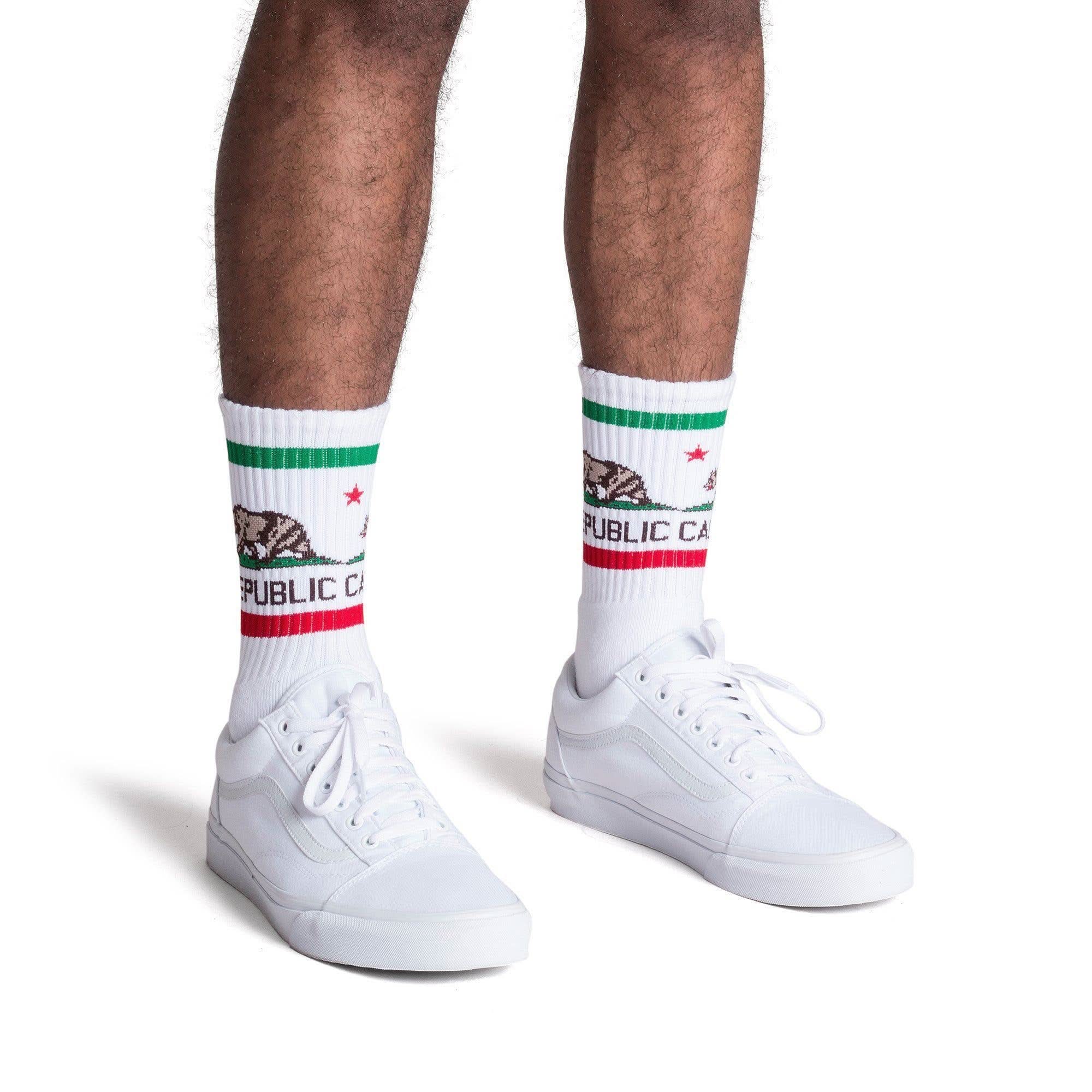 Man wearing California Republic tube socks with stripes and white shoes 