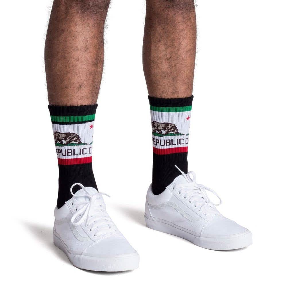 Man wearing black tube socks with California Republic flag and bear print 