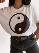 woman wearing hand printed, tucked t-shirt with distressed Yin-yang boho design