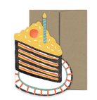 Slide of cake on a plate card with a brown envelope. 