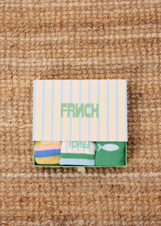 Set of folded napkins with 'FRENCH' branding on a textured surface